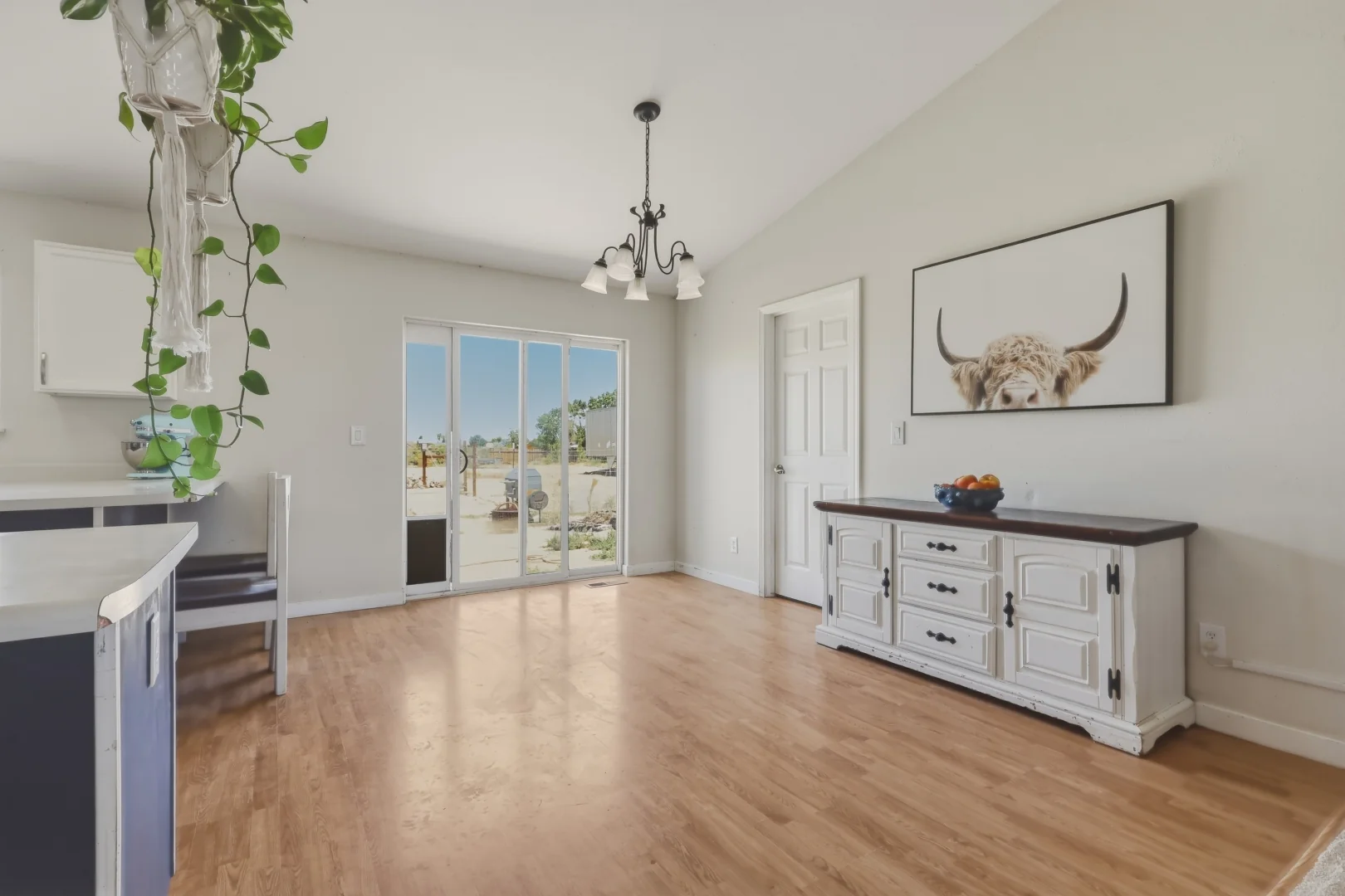 Dining area with vaulted ceiling and laminate floors
