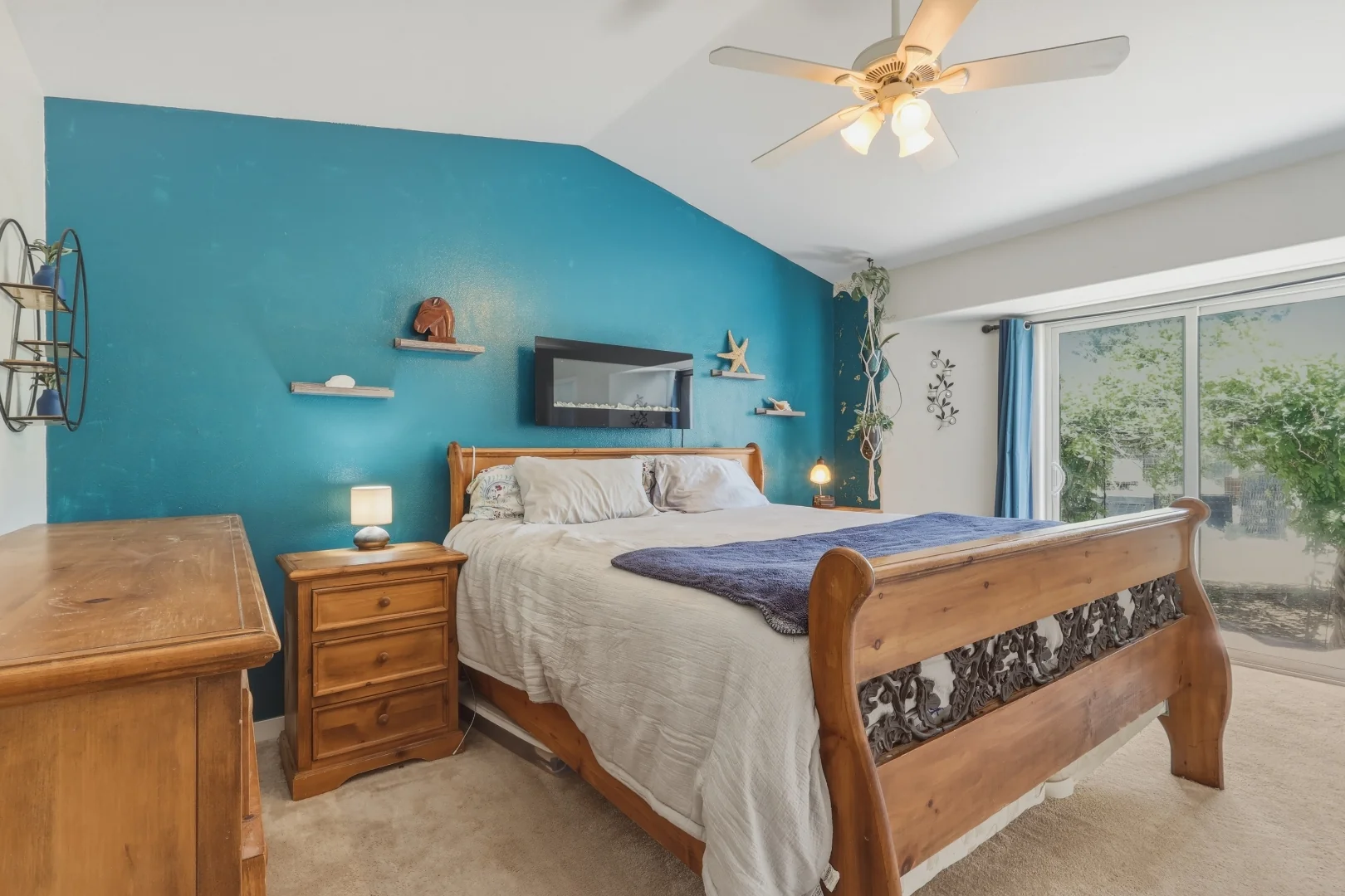 Primary bedroom on the main level with vaulted ceiling and ceiling fan