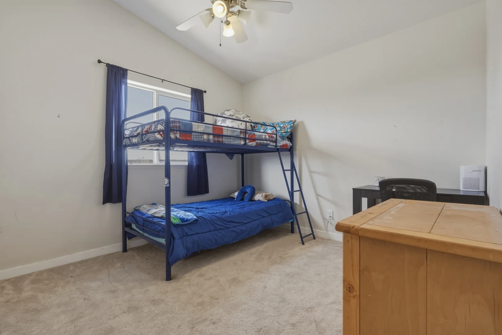 Third bedroom with vaulted ceiling and ceiling fan