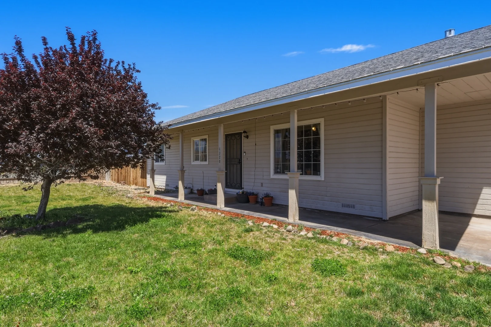 Wide angle of the front of the home with circular drive and 3-car garage